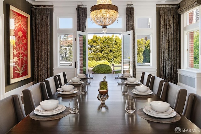dining space featuring a chandelier and crown molding