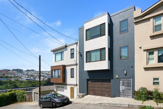 104 Bache St Unit A, San Francisco, CA 94110 - view of front of home with a garage, driveway, and stucco siding