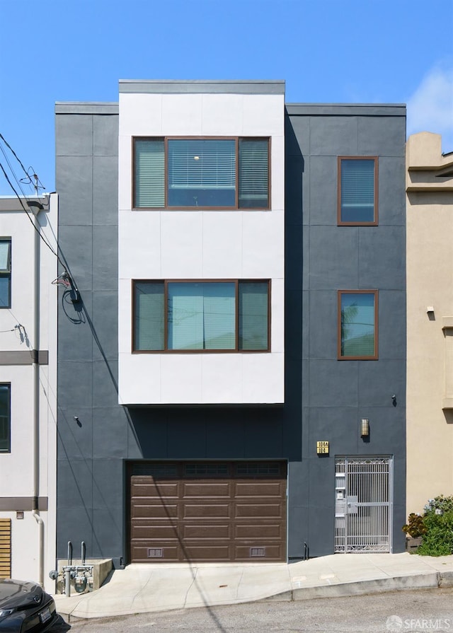 104 Bache St Unit A, San Francisco, CA 94110 - view of front facade featuring a garage, concrete driveway, and stucco siding