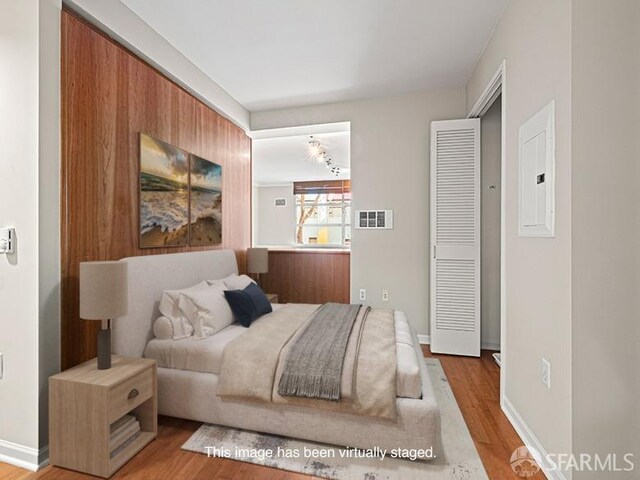 1701 Jackson St Unit 105, San Francisco, CA 94109 - bedroom with wood finished floors, electric panel, baseboards, and visible vents