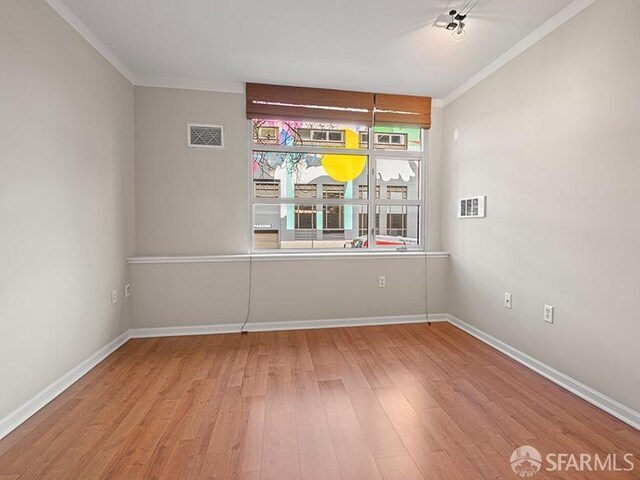 1701 Jackson St Unit 105, San Francisco, CA 94109 - spare room featuring ornamental molding, visible vents, baseboards, and wood finished floors