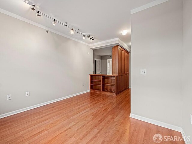 1701 Jackson St Unit 105, San Francisco, CA 94109 - empty room with light wood finished floors, baseboards, ornamental molding, and track lighting