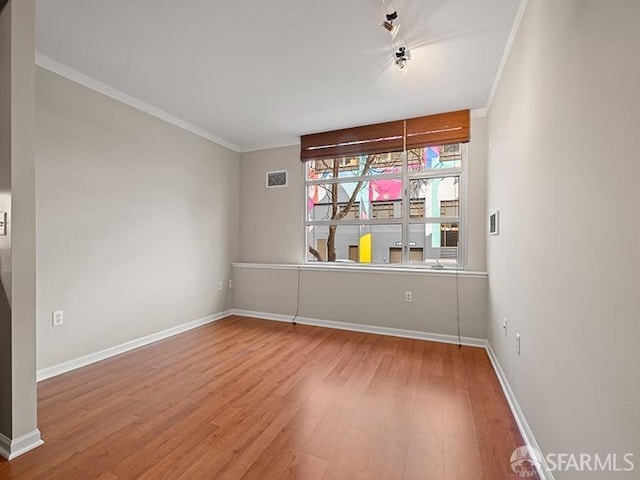 1701 Jackson St Unit 105, San Francisco, CA 94109 - spare room with visible vents, baseboards, ornamental molding, and wood finished floors