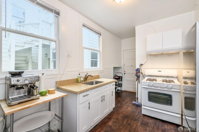 kitchen featuring white cabinets, sink, dark hardwood / wood-style flooring, and gas range gas stove