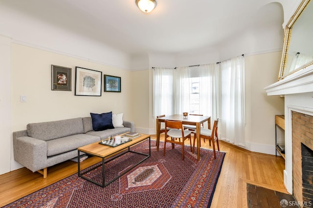 living room featuring hardwood / wood-style flooring and a fireplace