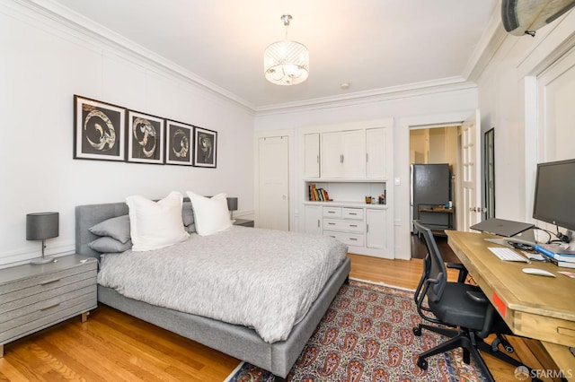 bedroom featuring light hardwood / wood-style flooring and crown molding