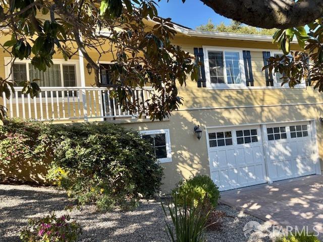 view of side of home featuring a garage