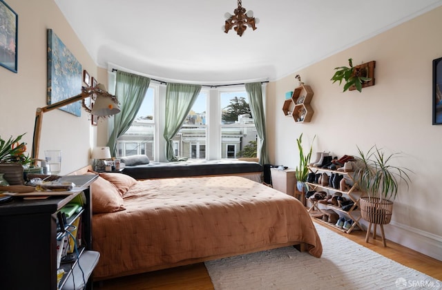 bedroom with baseboards and wood finished floors