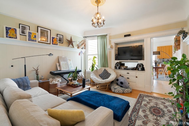 living area featuring light wood-style flooring and an inviting chandelier