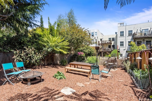 view of yard featuring an outdoor fire pit and fence