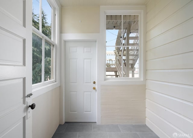 doorway to outside with tile patterned floors