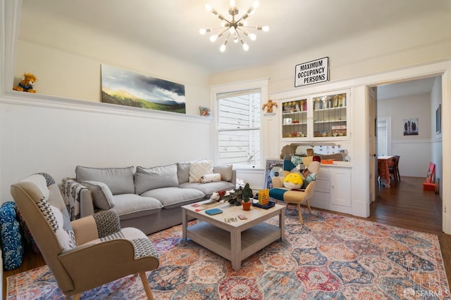 living area featuring wood finished floors and a notable chandelier