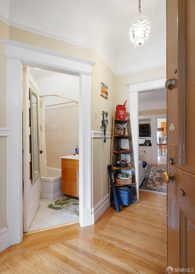 interior space featuring wood finished floors, shower / bath combo with shower curtain, and vanity