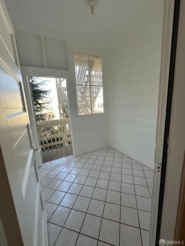 unfurnished sunroom featuring vaulted ceiling