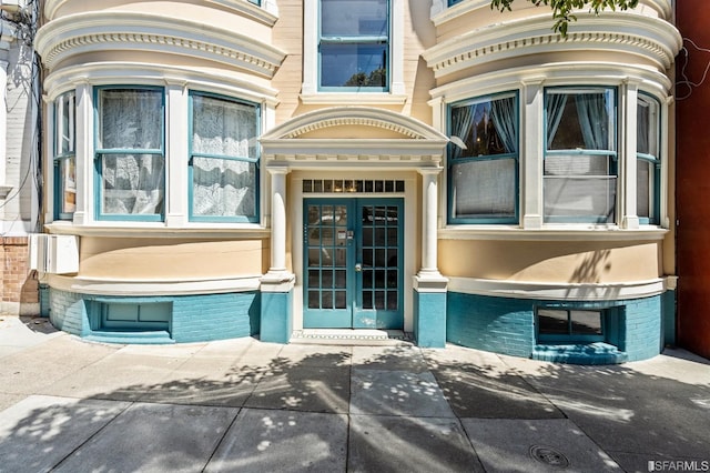 doorway to property with brick siding and french doors