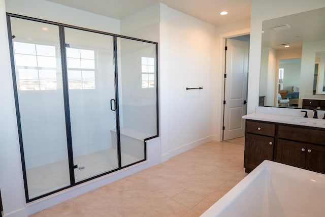 ensuite bathroom with ensuite bath, a freestanding bath, a shower stall, baseboards, and recessed lighting