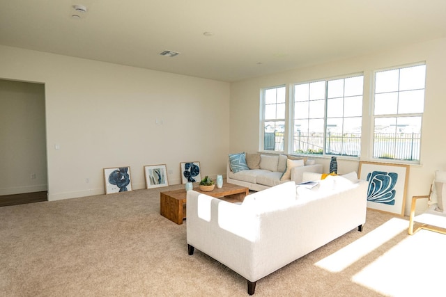 carpeted living room featuring baseboards and visible vents