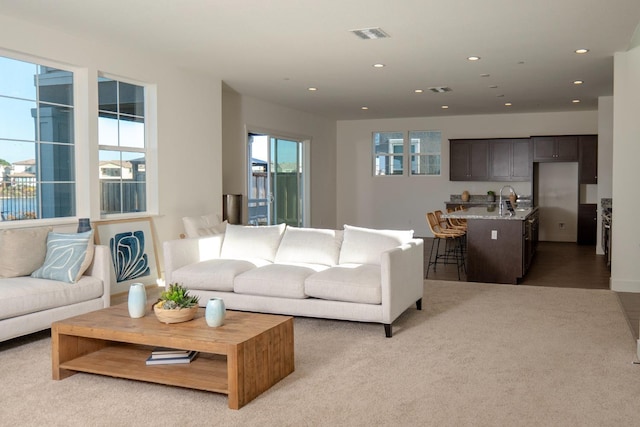 living room featuring recessed lighting and light colored carpet
