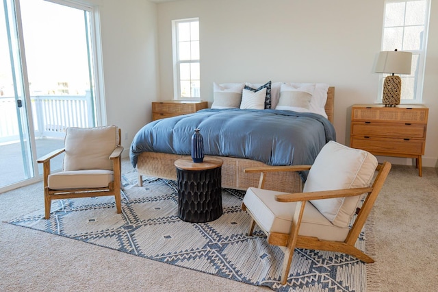 carpeted bedroom with access to exterior