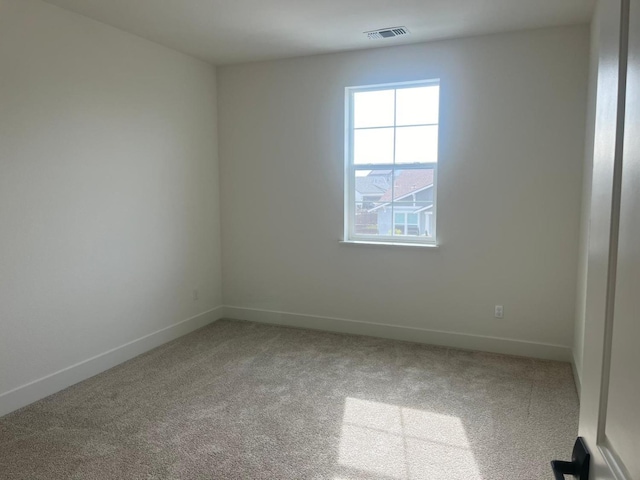 empty room featuring light colored carpet