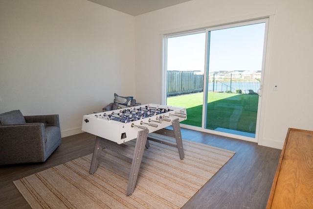 rec room featuring baseboards and wood finished floors