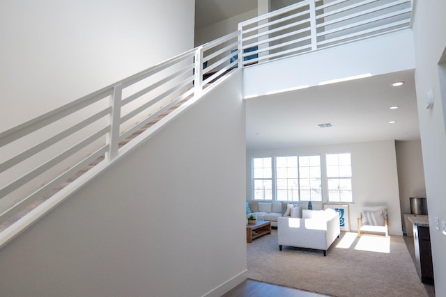 stairs with baseboards, recessed lighting, and wood finished floors
