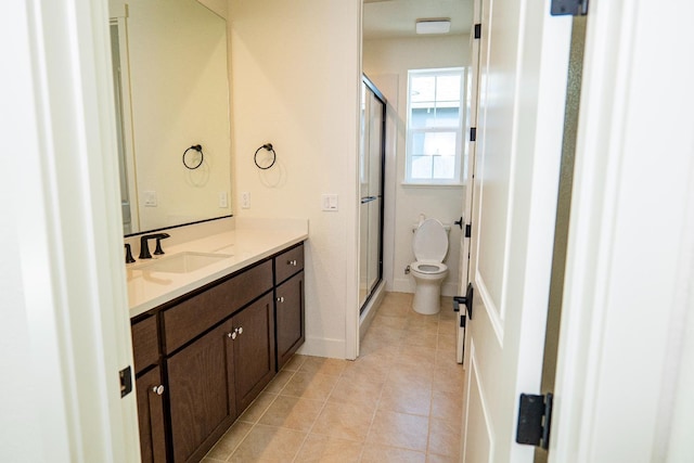 full bathroom featuring toilet, a shower stall, tile patterned flooring, and vanity