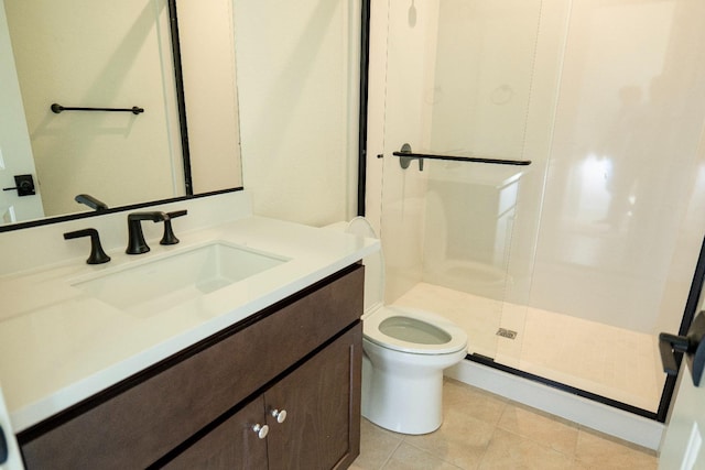 bathroom with vanity, tile patterned floors, a stall shower, and toilet