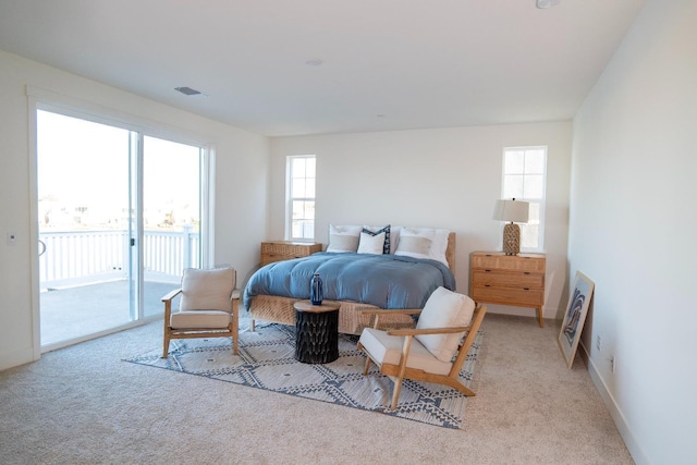 bedroom with visible vents, carpet flooring, baseboards, and access to outside