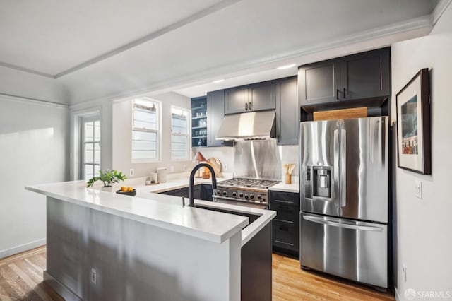 kitchen featuring kitchen peninsula, stainless steel fridge with ice dispenser, light hardwood / wood-style flooring, and sink