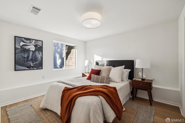 bedroom with wood-type flooring