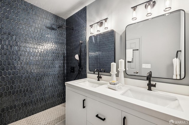 bathroom with vanity and tiled shower