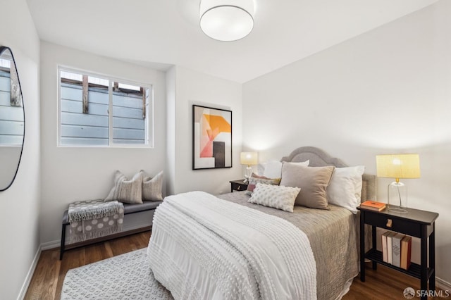 bedroom with dark wood-type flooring