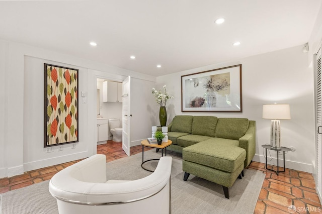 living room with baseboards and recessed lighting