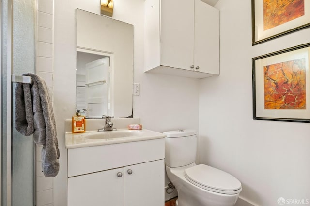 bathroom featuring vanity and toilet