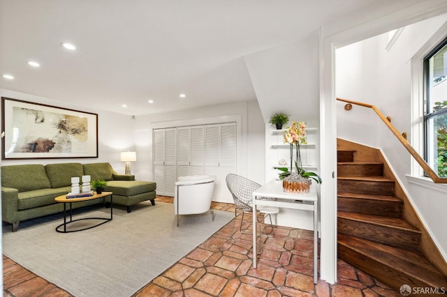 living area featuring stairs, baseboards, and recessed lighting