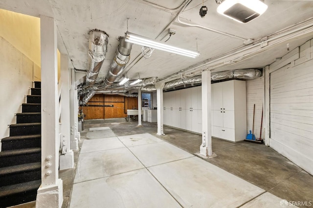 unfinished basement with stairs and a sink