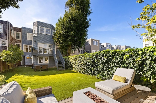 exterior space featuring stairs, a yard, an outdoor fire pit, and fence