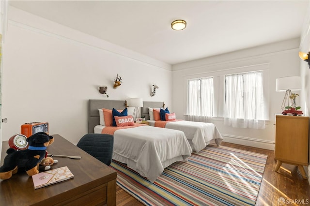 bedroom featuring baseboards and wood finished floors