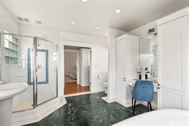 full bath featuring recessed lighting, visible vents, a shower stall, and toilet