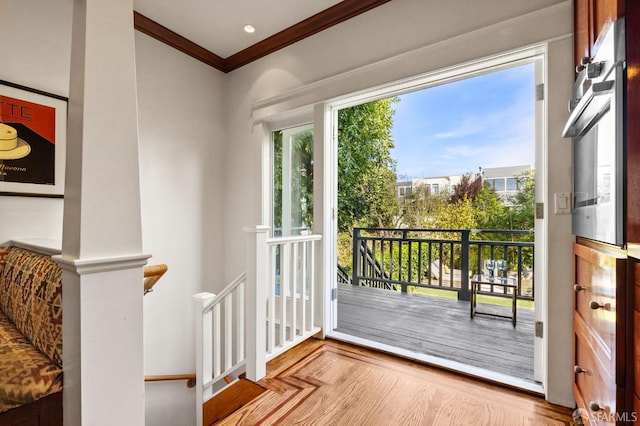 entryway with parquet floors and ornamental molding