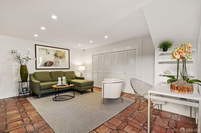 living room featuring baseboards and recessed lighting