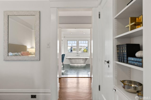 corridor featuring wood finished floors