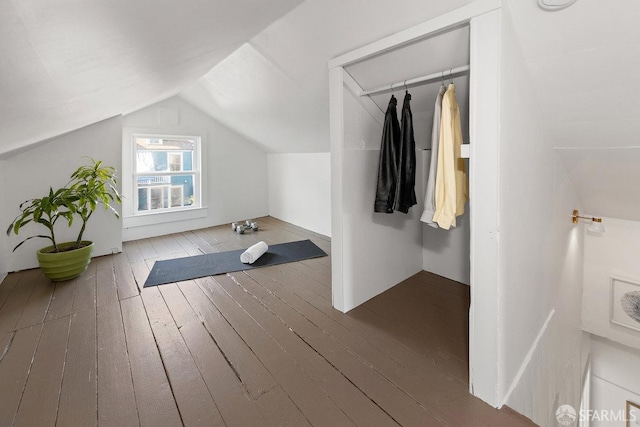 additional living space featuring lofted ceiling and hardwood / wood-style floors