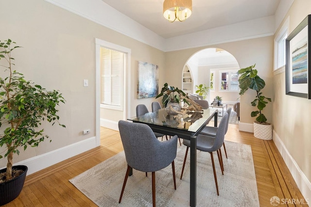 dining area with an inviting chandelier and light wood-type flooring