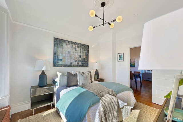 bedroom featuring dark wood-type flooring and a notable chandelier