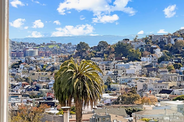 property's view of city featuring a mountain view