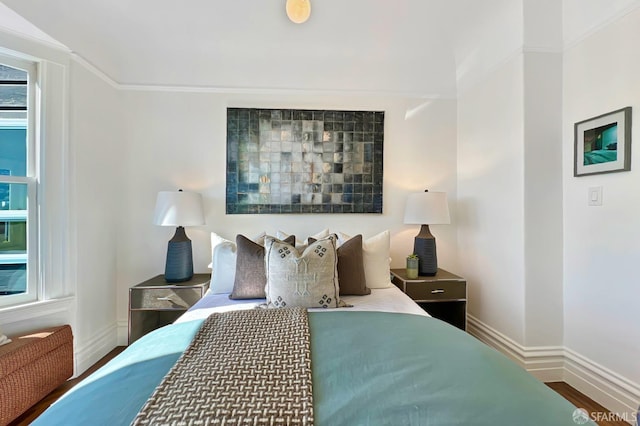 bedroom featuring wood-type flooring and ornamental molding