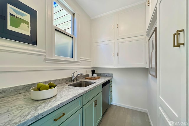 kitchen with sink, light hardwood / wood-style flooring, dishwasher, light stone countertops, and green cabinetry