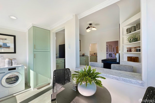 dining room featuring washer / clothes dryer and ornamental molding